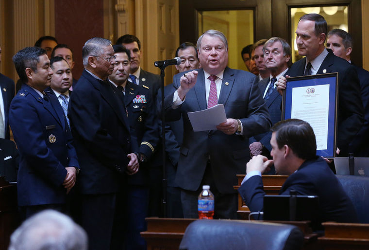 Del. L. Scott Lingamfelter, R-Prince William, Col., USA, (Ret), center, at microphone, presents a resolution honoring Japanese-Americans who have served in the US military during a ceremony in the House of Delegates chamber at the State Capitol in Richmond, VA Tuesday, Feb. 24, 2015. Four of the honorees are Col. Derek Hirohata, USAF, left, Capt. Wade Y. Ishimoto, US Army Special Forces, (Ret), 3rd from left, Lt. Col. Mark Nakagawa, USA, (Ret), 4th from left, and Col. Dale Shirasago, USAF, (Ret), just behind Lingamfelter, left. -- BOB BROWN/TIMES-DISPATCH
